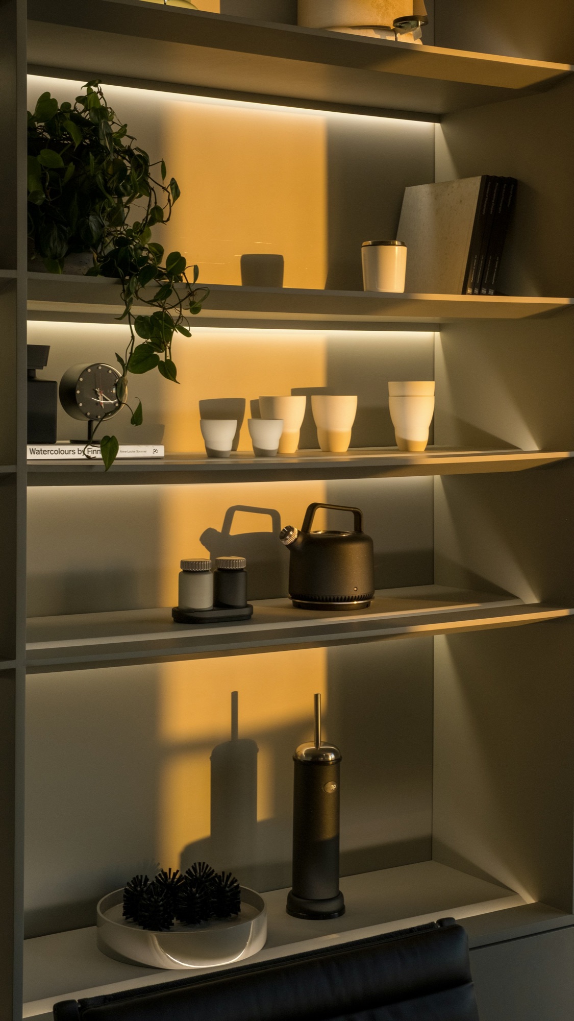 Warmly lit shelves of curated home décor at Platt Designs
